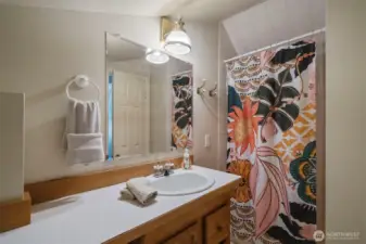 The loft is complemented by a full bathroom, an ideal setup for guests or extended living.