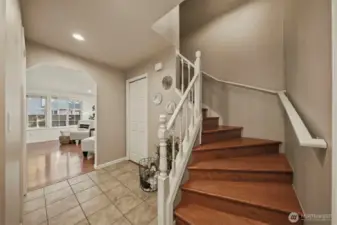 Inviting front entry where tile floors and a beautiful staircase create a warm and welcoming first impression.
