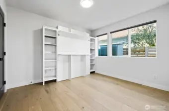 Second bedroom on main level with Murphy bed. Bed to convey.