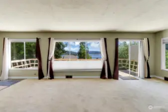 Slicing glass doors in living room lead out to expansive view deck.