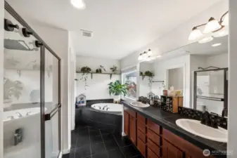Primary ensuite with large soaking tub, double vanity & walk in shower.