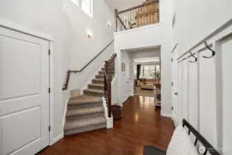 Open foyer looks down the hallway to family  room or up the open staircase to the loft area  above