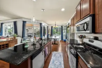 So many windows! Stainless steel  appliances, granite countertops, under mount sink,  gas stove-what's not to love?