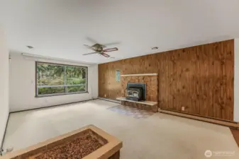 Living room with wood burning insert fireplace.
