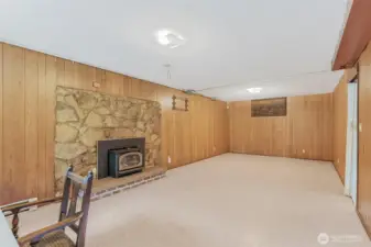 Rec room in lower level with wood burning insert