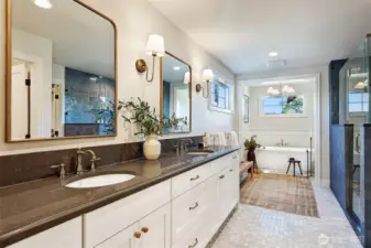 Spa-inspired primary bathroom includes radiant heated tile floors throughout, dual-sink vanity, free-standing tub, separate shower with gorgeous tile and a water closet. Enormous walk-in closet is accessed through the bathroom.