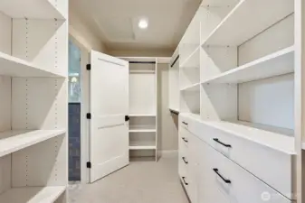 Primary suite walk-in closet with tons of built-ins.
