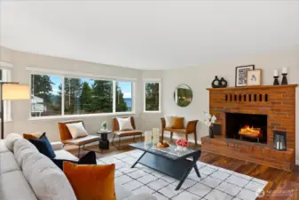 Large living room with cozy wood burning fireplace and sound & mountain views.
