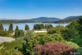Panoramic Lake Sammamish and Cascade views framed by lush, mature landscaping for privacy and serenity.