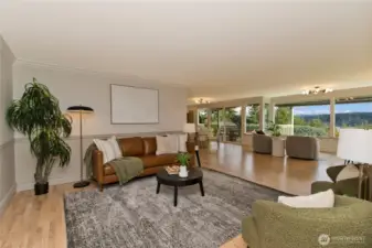 Open living room with panoramic lake and mountain views.