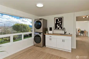 Spacious laundry room with convenient sink and storage.