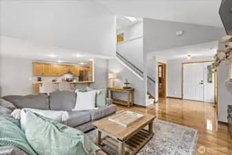 Open concept living on the lower level with laminate floors throughout and a cozy gas fireplace in the living room.