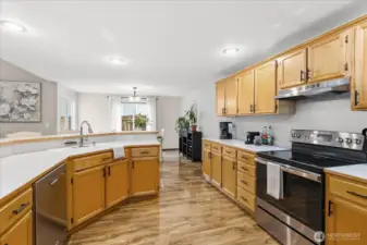The kitchen offers a high bar with room for 4 chairs, stainless appliances and pantry space.