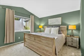 Primary ensuite offers vaulted ceilings, full bath and walk in closet.