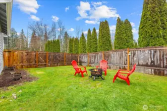 Fully fenced side yard with patio area located off of the  dining room.