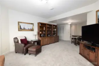 Family room looking toward stairs and hallway to bedrooms, bath, utility room, and storage