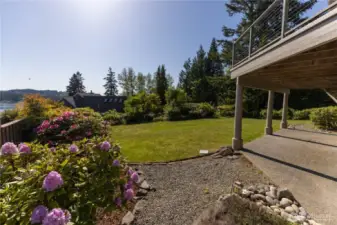 Lush landscaping in the mostly fenced backyard