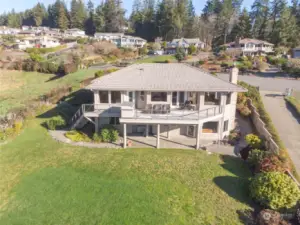 Daylight basement with a large deck upstairs and full patio on the lower level. The home has a greenbelt on one side and the community beach access path on the other side