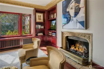 This is one of 4 gas fireplaces on the main floor. Love that original stone surround.