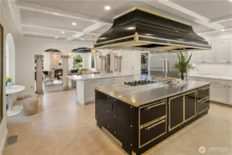 This is a first for me. I have never seen a Officine Gullo cooking island & commercial grade hood: 4 burners, induction station, griddle station, pasta/steamer station, prep area, convection oven, gas oven & warming area with 2 levels! Like a big lovely piece of jewelry for your kitchen! Also in the kitchen, an island for watching the cooking/TV while eating with room for 6 stools. Two Miele dishwashers, and a full size Miele refrigerator & freezer, 2 sinks, curved breakfast nook & so much more! Notice the adjoining family room through the archways....