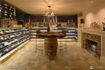 Behind a 300lb door with ornate ironwork and glass (& secured by a boimetric lock)...your 1250 bottle capacity awaits! There is a racking system to ensure that every bottle's label can be seen, including low power LED lights shining sown on the bottles. Venetian plaster walls and a travertine tile floor.