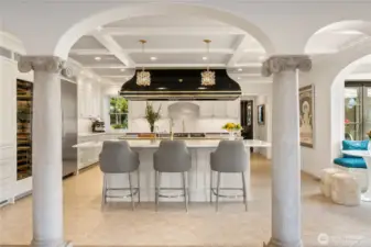 This photo is taken from the family room looking back at the kitchen. Did I forget to mention the full size wine fridge-it is to the left of the column in this photo. Also, you can see now the beautiful box-beamed (painted tin) ceiling in the kitchen. The doorway at the back of the photo leads to the formal dining room.
