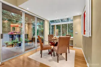 The dining space is wrapped in windows, bringing the outdoors inside