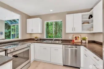 Updated kitchen features tiled floor, Stainless Steel Appliances, underlit cabinets and slab granite counters
