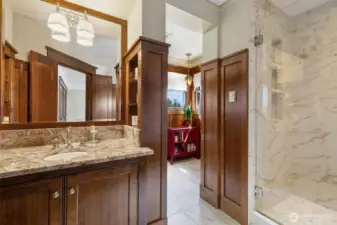 Well designed primary bathroom with two sinks, toilet, and a gorgeous shower.