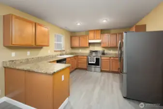 Gatherings and entertaining will happen is this spacious kitchen with beautiful granite countertops