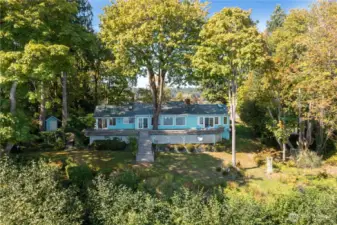 Well kept yard surrounded by old growth trees