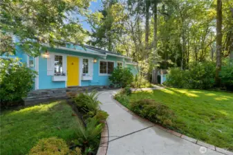 Front entrance has flowers, herbs, trees