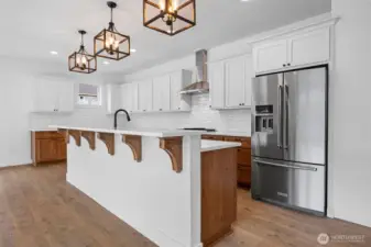 The kitchen area with 10ft eating or buffet serving bar. Very well done tiled back splash, both wood grain and painted cabinets. A must come and see to truely appreciate this beautiful; kitchen