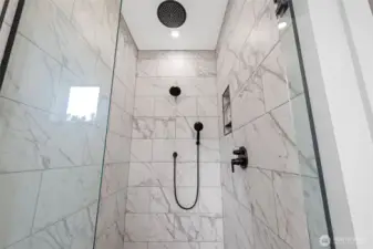 Feel pampered in this beautiful tiled, glass shower with  3 shower heads including a rain shower  head