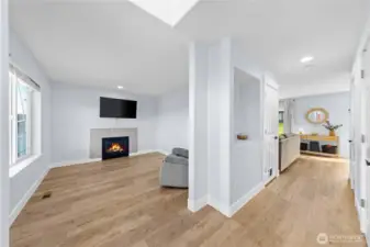 Entry leads to front room, hall to living room, and powder room.