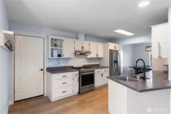 Garage leads directly into the kitchen with a coat rack in the drop zone.