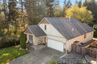 The roomy drive offers plenty of parking and the garage has added ceiling storage racks. The shed on the side of the home is also included