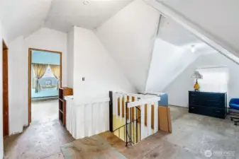 Up the spiral stairs awaits 2 more bedrooms.