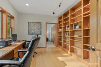 Main floor office with built-in shelving and tranquil outlook.