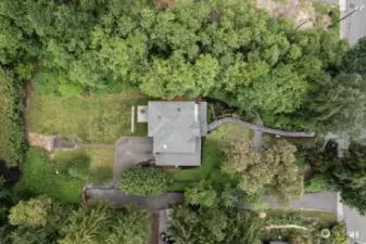 Aerial view showing how the house is sited in the center of the lot adding to its privacy and park-like feel. Or leaving room to potentially subdivide additional lots on either side.