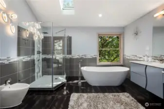 The primary bathroom is enhanced by skylights, heated floors and includes a bidet, bathtub, and separate shower.