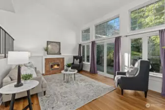 Spacious living room featuring French doors that open to the backyard