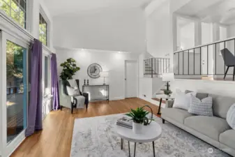 Spacious living room featuring French doors that open to the backyard