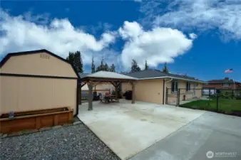 Oversized driveway with gazebo, shed, greenhouse & garden area. This has a gate that closes to completely fence in this area.