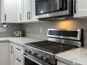 Bright open kitchen with quartz counters & gas cook top