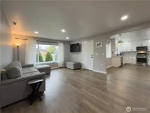 Living room open to the bright kitchen