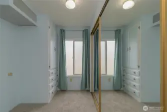 Dressing area with closets and drawers off of the Primary Bedroom