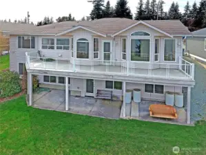 Back of home with upper deck and lower patio to enjoy the amazing views
