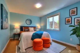 The lower level bedroom seen with a queen bed.