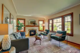 The living room enjoys honey oak floors, coved ceilings and a cozy gas fireplace.